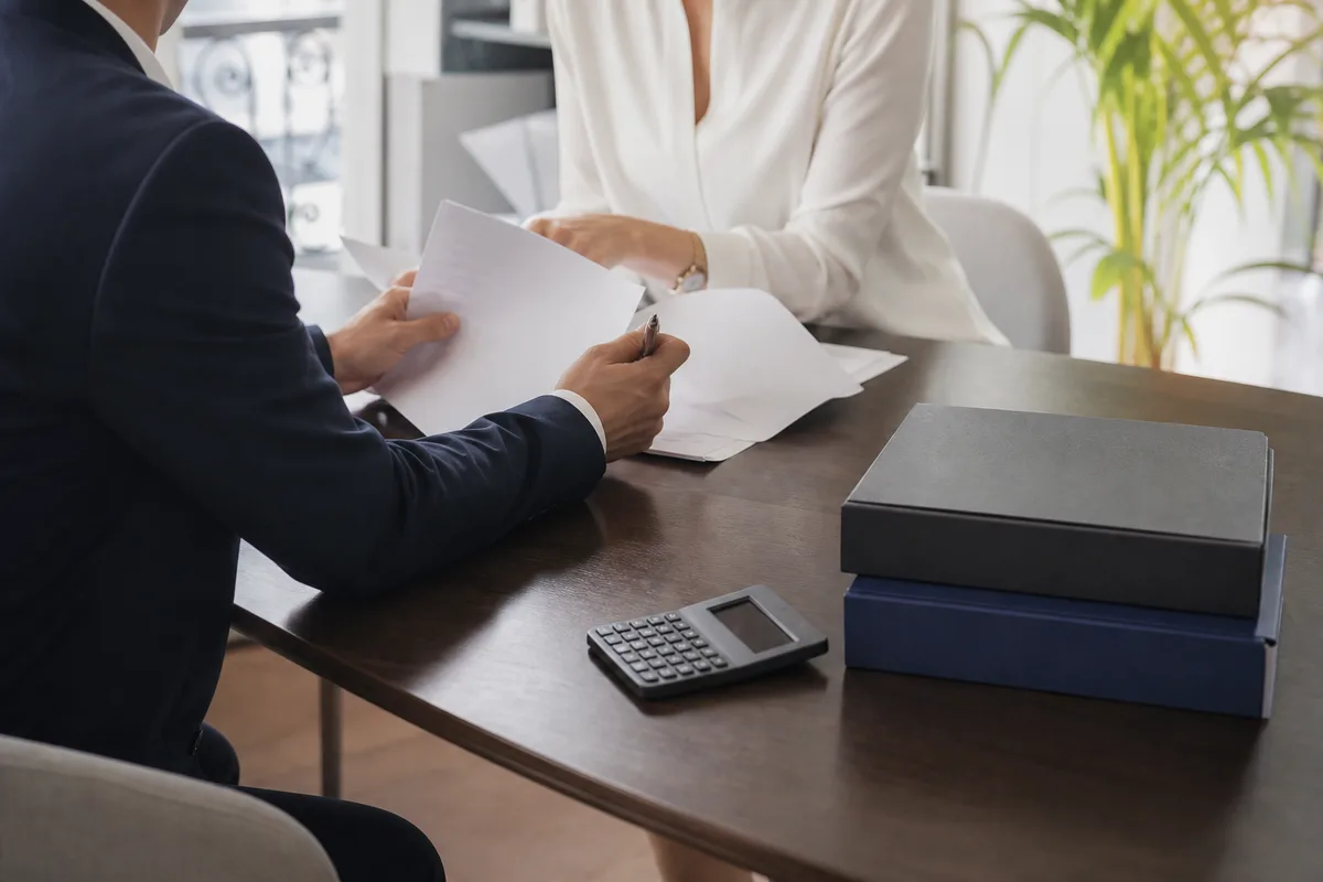 Dirigeant et comptable examinant des documents autour d’une table de réunion